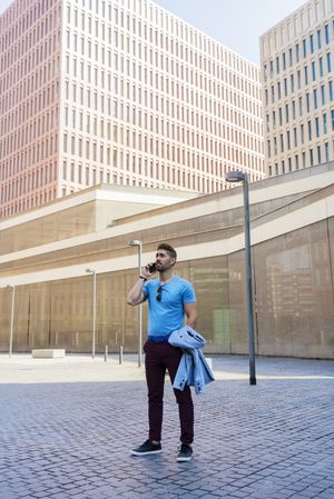Confident man talking on his phone outdoors