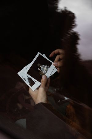 Person hands showing instant photos