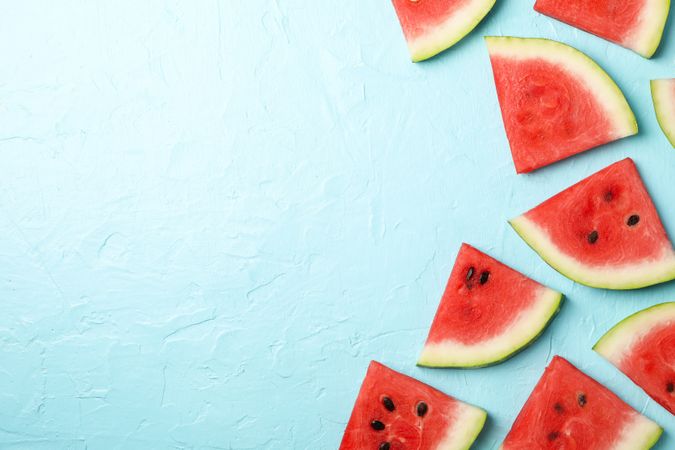 Composition with watermelon slices on blue background, top view