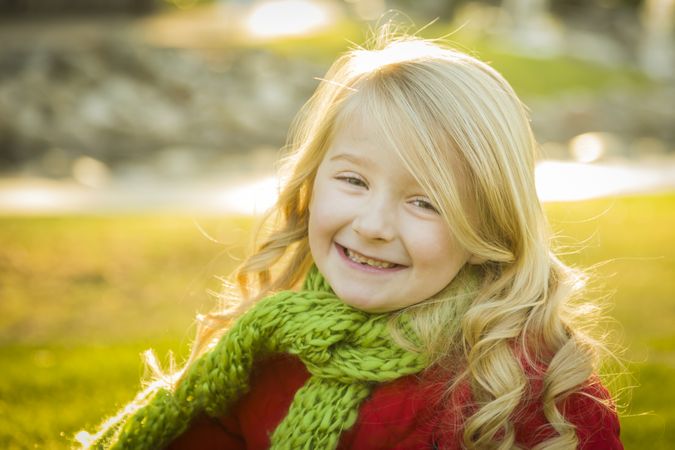 Little Girl Wearing Winter Coat and Scarf at the Park.