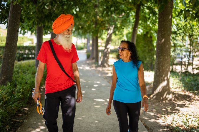 Mature Sikh couple strolling through park