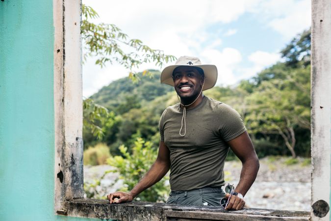 Black man wearing a hat at a window