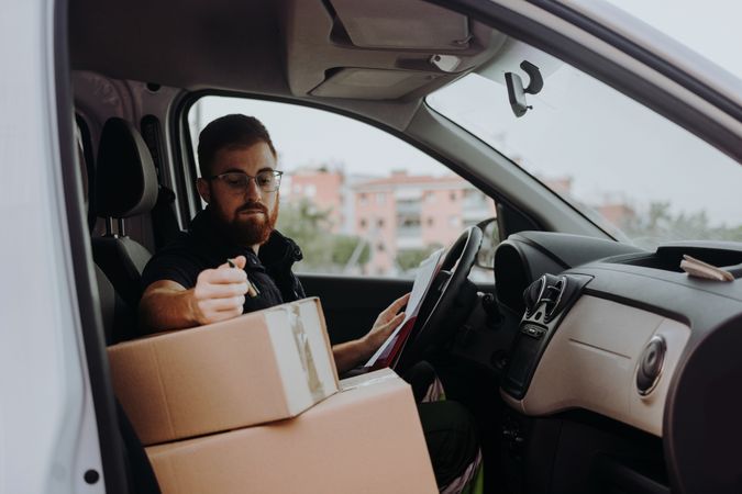 Courier preparing cartons for express delivery