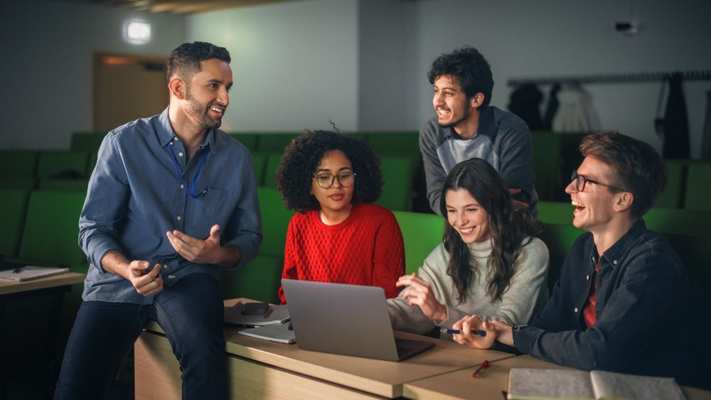 Diverse Happy Students Having a Conversation with a Teacher in University Classroom