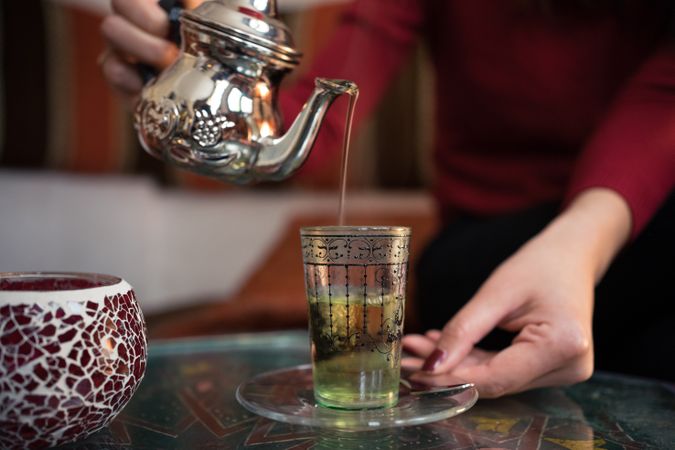 Asian woman enjoying Arabic tea