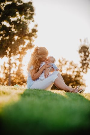 Grandma kissing his grandson with down syndrome in the park