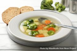 Vegetable soup on wooden table with break 43dDPb