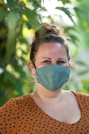 Confident woman wearing homemade coronavirus mask looking at camera