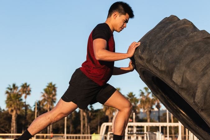 Strong man doing tire flip exercise