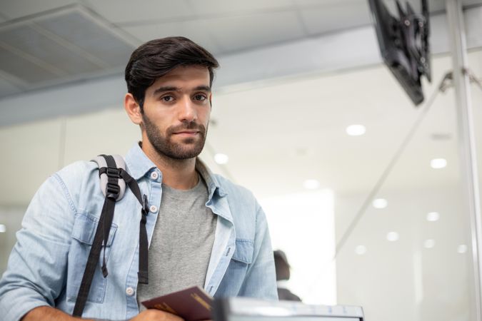 Male with passport awaiting check in at airport