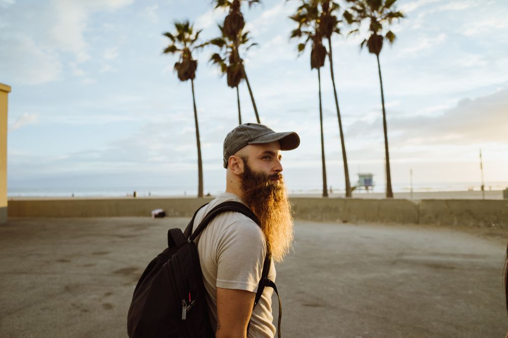 Bearded traveler near beach