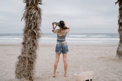 Young female relaxing on beach with hat