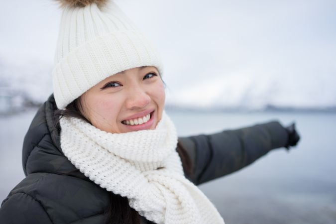Joyful young woman in warm clothes