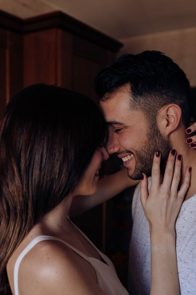 Happy couple embracing in kitchen
