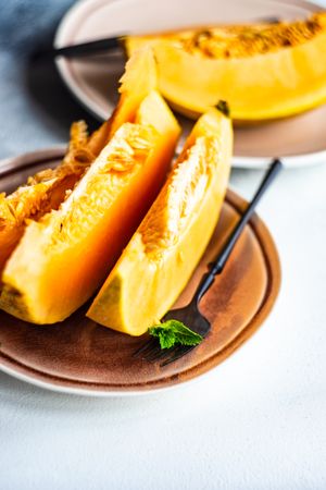 Slices of orange melon served with fork