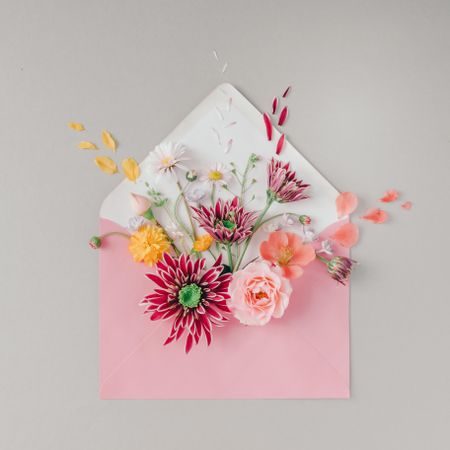 Pink envelope full of various flowers
