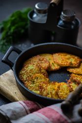 Pan cooking Ukrainian potato pancakes, deruny