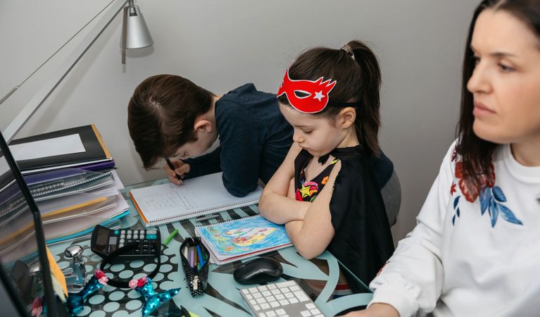 Woman teleworking with her son and angry daughter