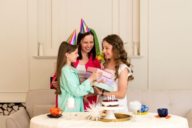 Birthday girl given gifts by mother and sister