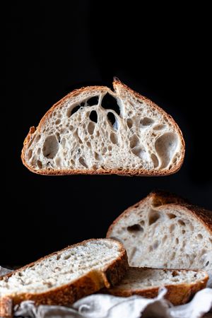 Slices of fresh bread falling on table
