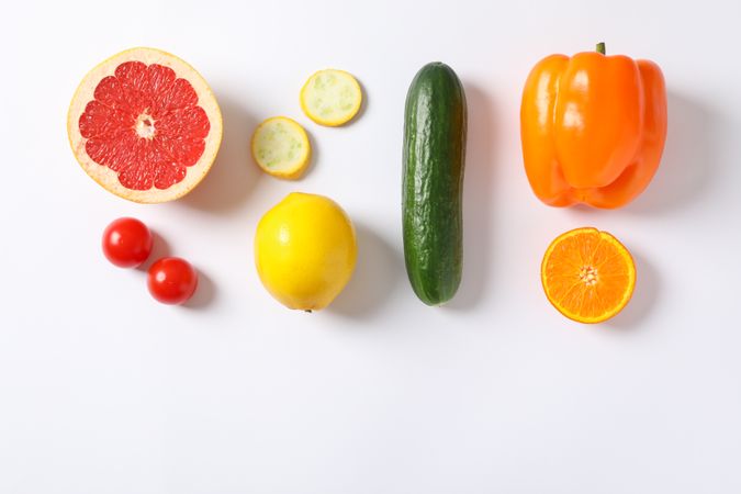 Flat lay with vegetables and fruits on plain background, space for text