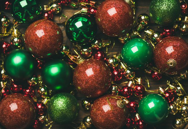 Close up of tree ornaments, large and small red, green and gold baubles