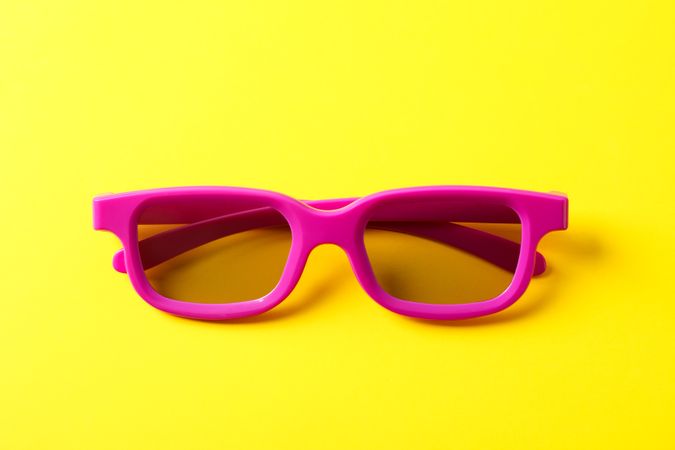3d glasses on yellow background, close up