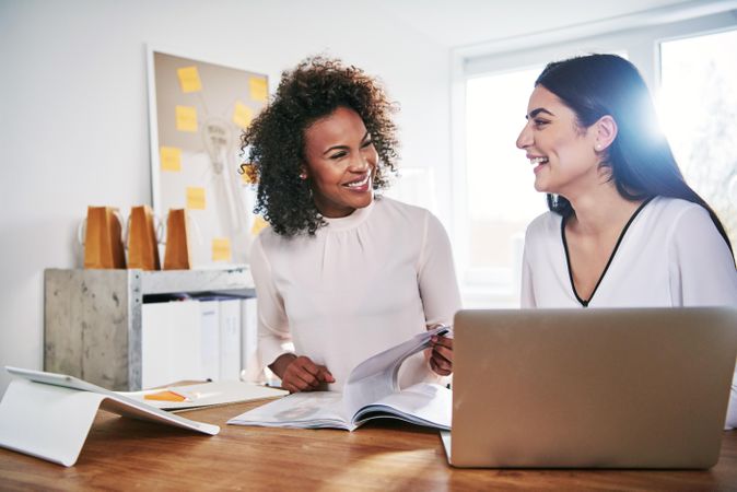 Two woman working together in a bright home