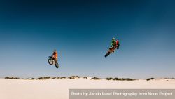 Motocross racers jumping bikes and doing stunts in desert 4Oolv4