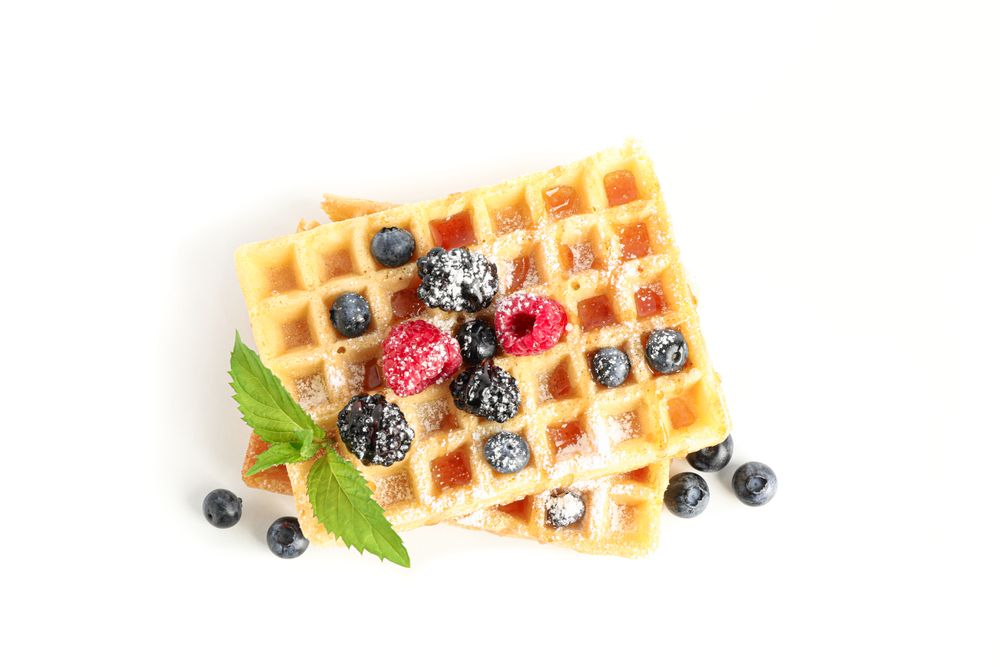 Waffles with berries and mint isolated on blank background