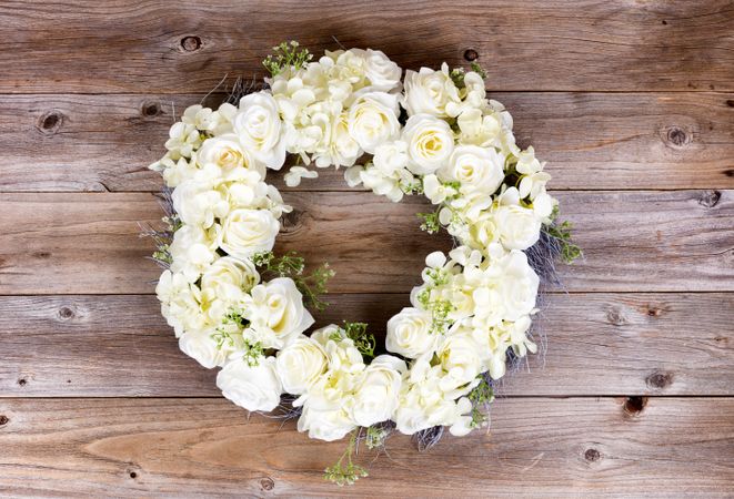Flowers forming wreath on rustic wooden planks