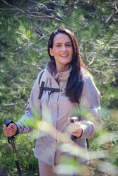 Delighted Hispanic female hiker in woods