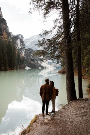 Resting couple enjoying views of lake and mountains