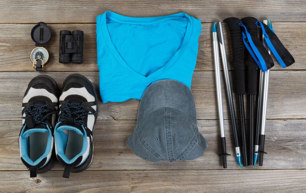 Blue color coordinated outdoor walking accessories on rustic wood