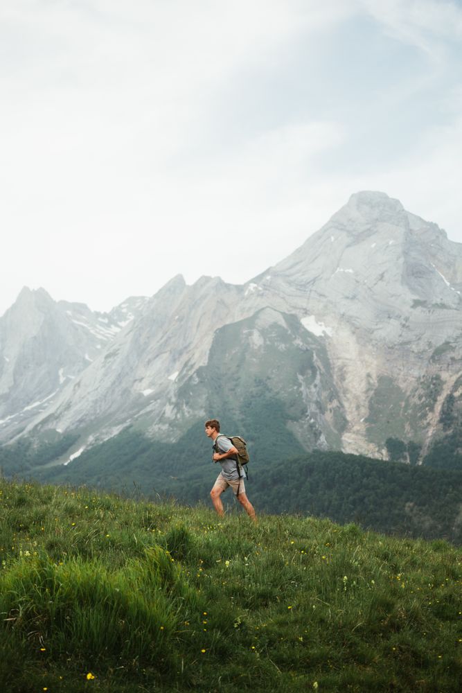 Unrecognizable man with backpack hiking in Pyrenees mountains