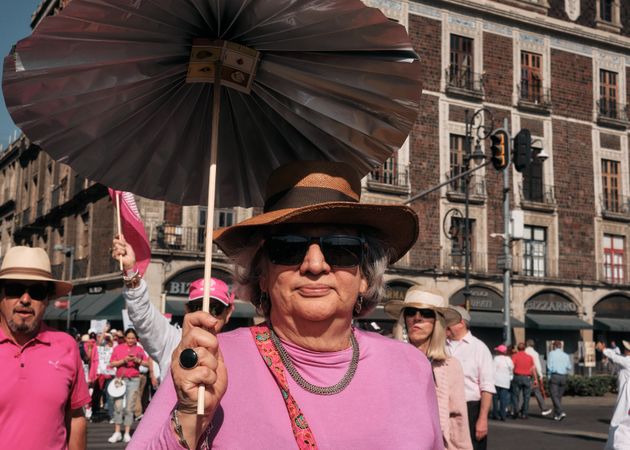 Mexico City, Mexico - February 26th, 2022: Older woman with parasol at protest