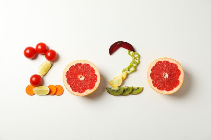2020 laid out of fruits and vegetables on plain background, copy space
