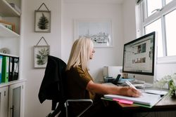Woman with grey hair working from home