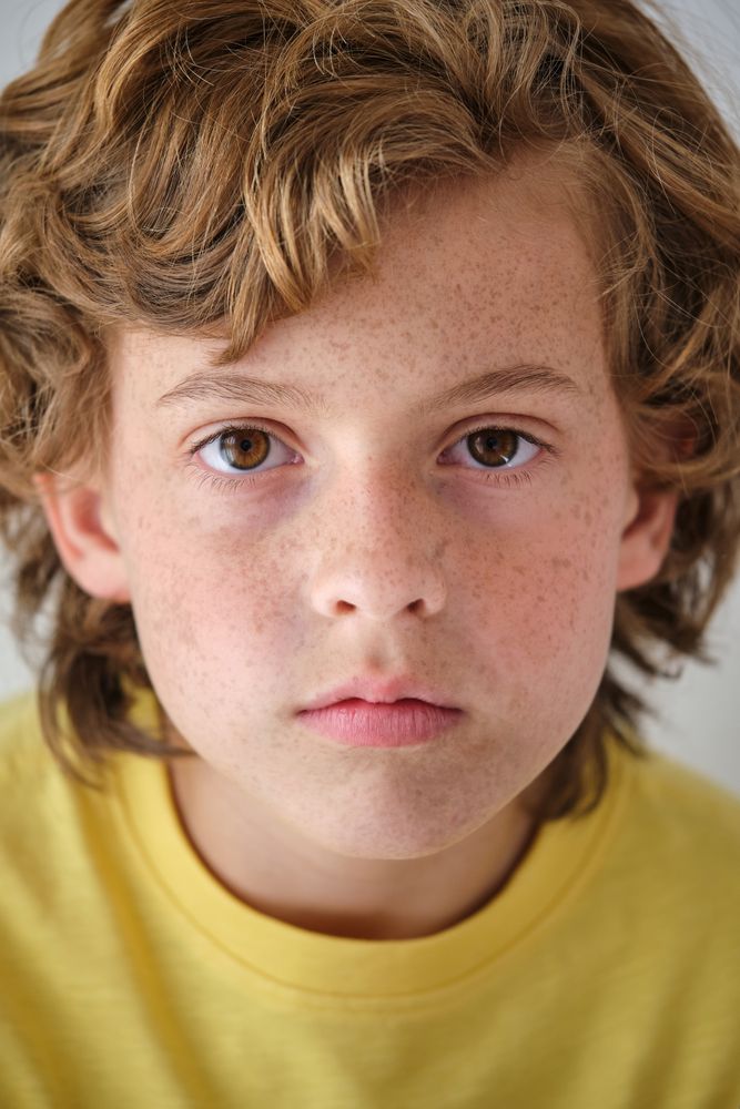 Crop boy with freckles and wavy hair