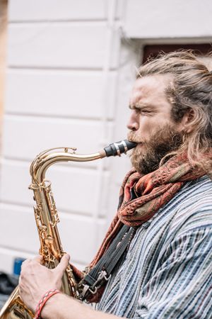Male saxophonist plays Sax in the street