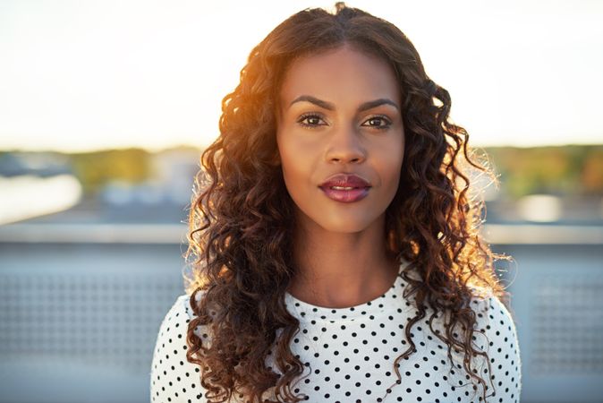 Close up of woman standing outside looking at camera