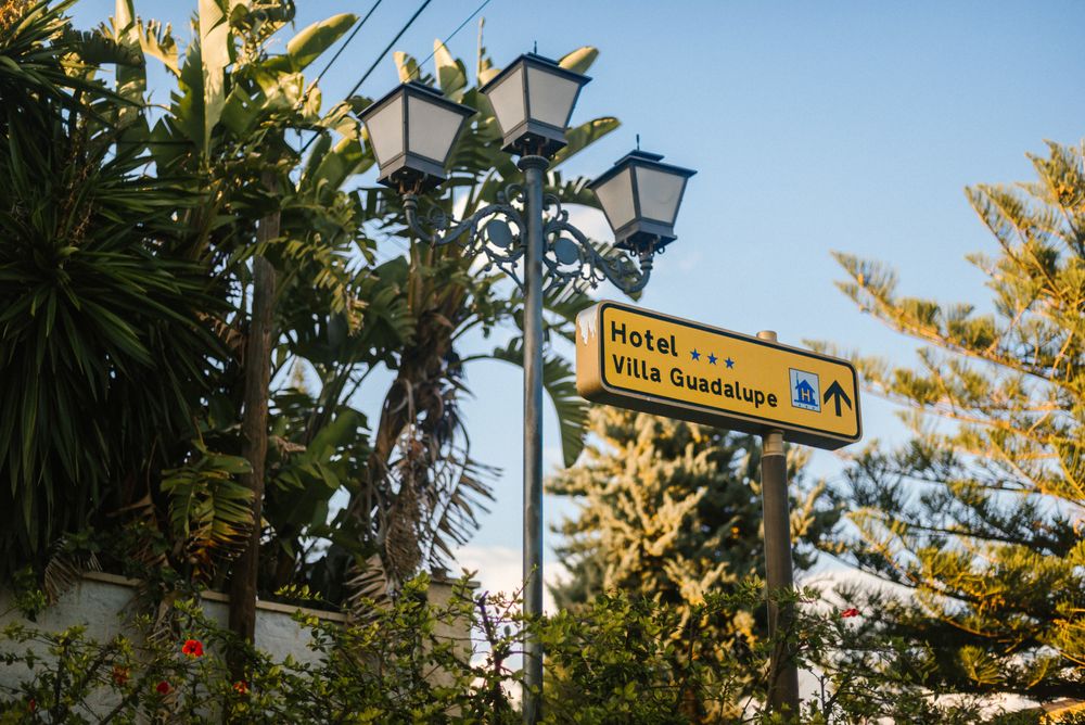 Sign and lamppost near hotel