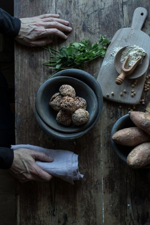 Person rolling in breadcrumbs sweet potatoes