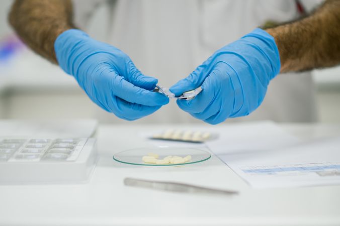 Crop pharmacist making personalized pills for client