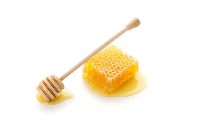Honeycomb and dipper isolated on neutral background
