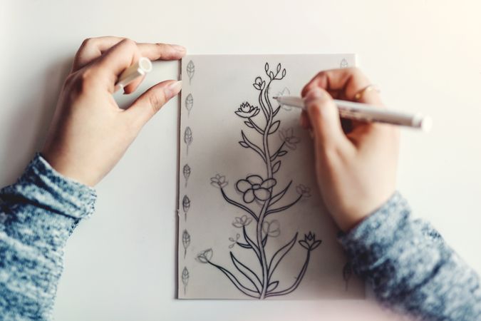 Woman doing linearity on paper at table