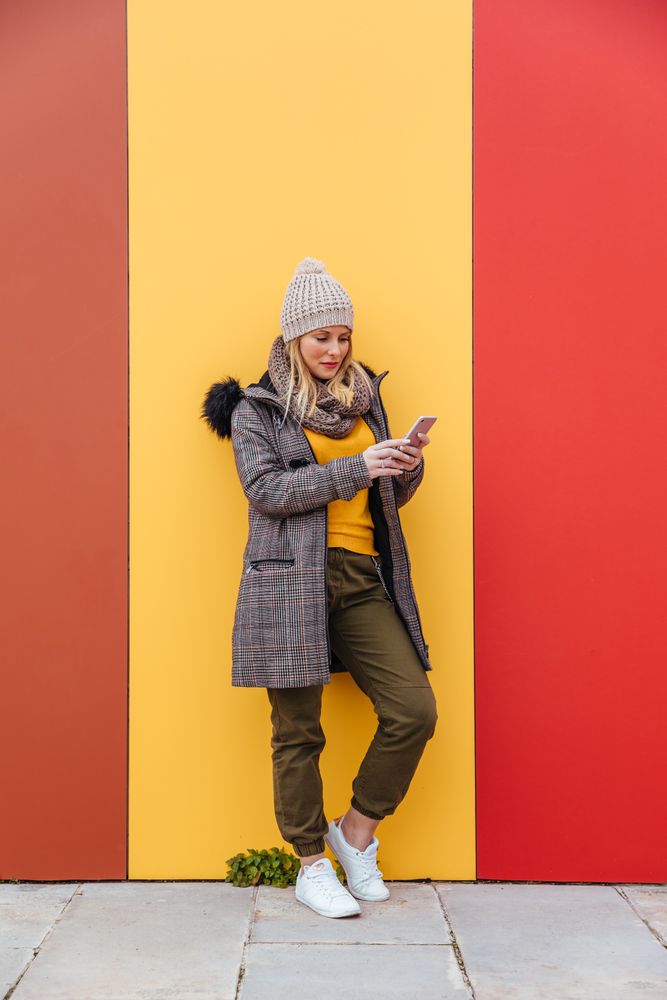 Portrait of blonde woman writing on her phone