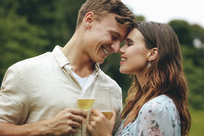 Romantic couple at the park with champagne glasses