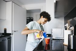 Girl preaparing a cup of milk