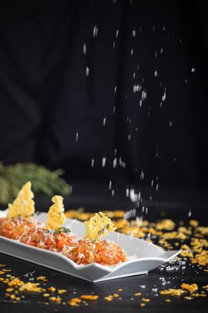 Tasty Quenelles of tomato fondue and Parmensan tile in ornamental plate